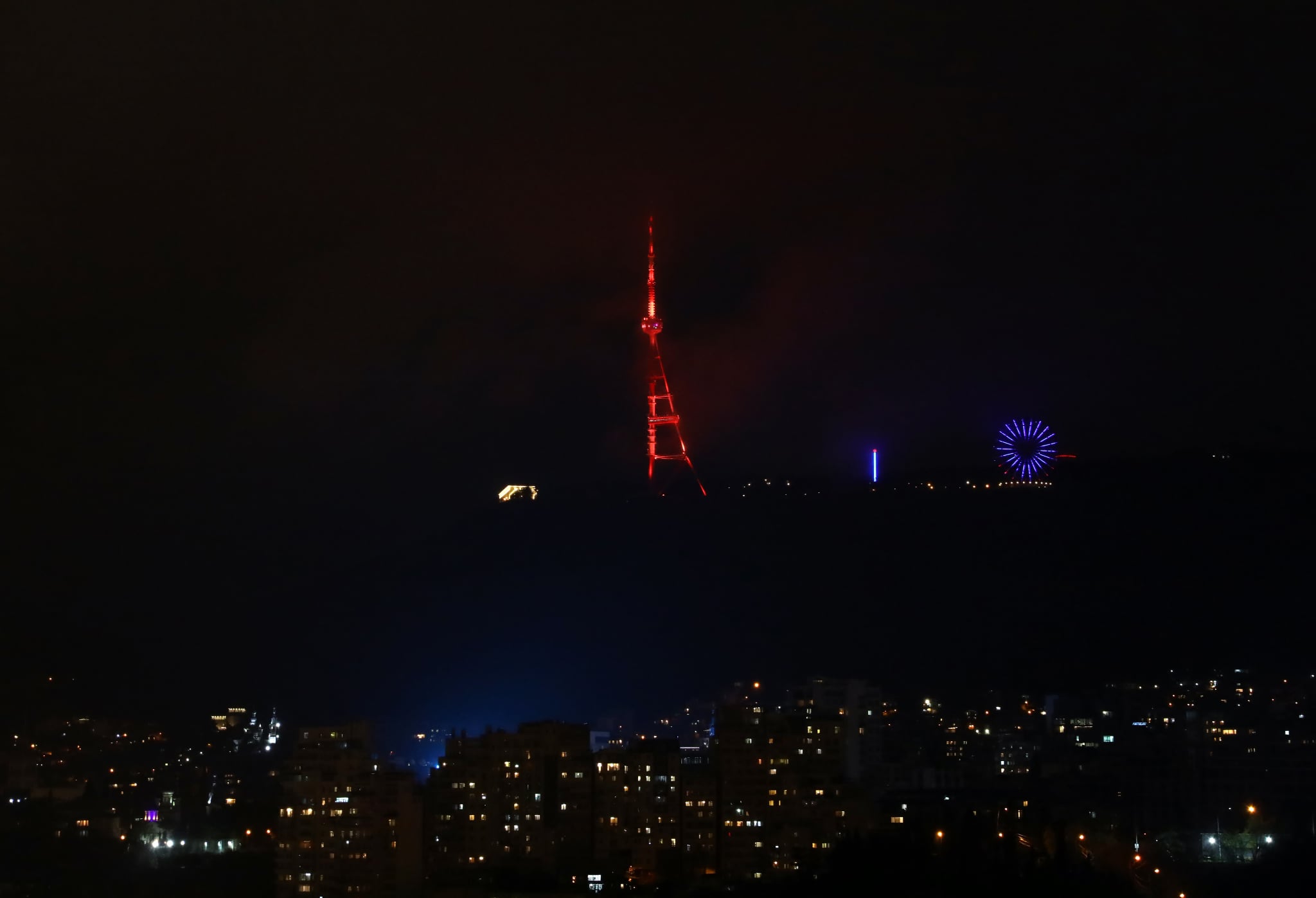 Tbilisi TV Tower lit up in orange